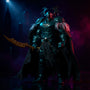 Black fabric action figure cape with internal wire framework and hand-sewn seams, flowing dramatically against a dark gothic city skyline with spotlight and smoke, bold gradient background.