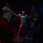 Black wire-edged fabric cape draped over an armored Batman action figure in a gothic diorama with red and blue LED lighting and smoke.