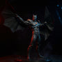Black fabric cape with wire edges draped over an armored Batman-style 7-inch figure in a Batcave diorama with red and blue LED lighting and smoke.