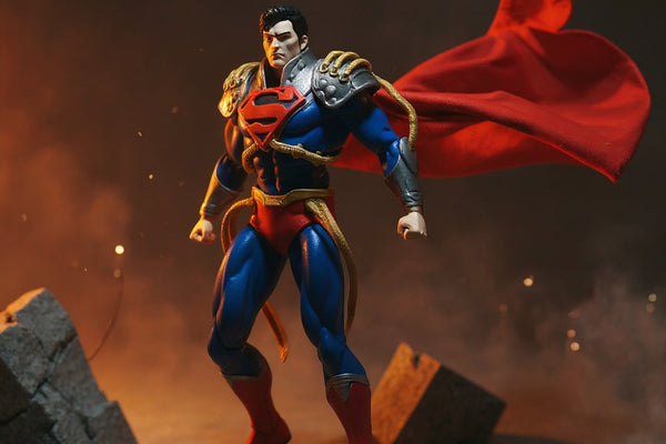 Wired deep red cape with gold trim on action figure torso on cracked concrete base with red-yellow backlight and city skyline