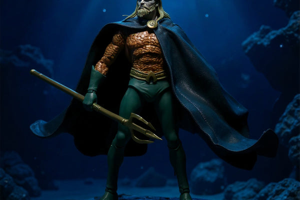 Dark blue teal fabric cape with wire framework displayed in underwater diorama with trident prop and blue gel lighting
