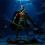 Dark blue teal fabric cape with wire framework displayed in underwater diorama with trident prop and blue gel lighting