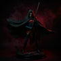 Dark flowing fabric cape with visible stitched seams and wire-outlined edges, displayed on a stand in a gothic diorama with fog, ruined cityscape, chains, and dramatic lighting.