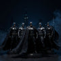 Six Batman action figures with fabric capes on a display base with Bat-Signal on a Gotham rooftop diorama.