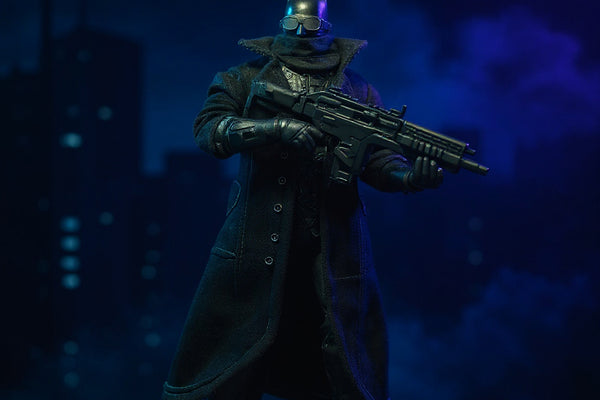 Matte black textured fabric trench coat with bendable wire edges draped on a dark-armored Batman-style action figure on a rooftop diorama with gothic cityscape and dramatic spotlighting.