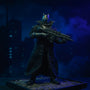 Matte black textured fabric trench coat with bendable wire edges draped on a dark-armored Batman-style action figure on a rooftop diorama with gothic cityscape and dramatic spotlighting.