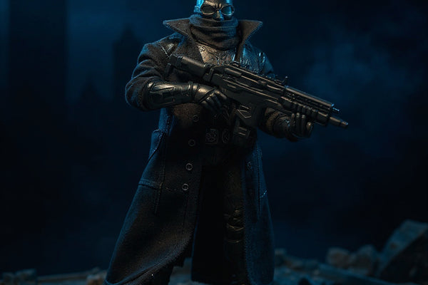 Matte black textured fabric trench coat for 7-inch action figure with wire hem and collar, draped on Batman-style figure on Gotham rooftop diorama under dramatic spotlight.