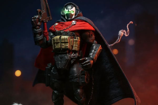 Dark tactical cape on action figure posed on rooftop diorama with dramatic spotlight and fog, against bold gradient sky