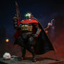 Dark tactical cape on action figure posed on rooftop diorama with dramatic spotlight and fog, against bold gradient sky