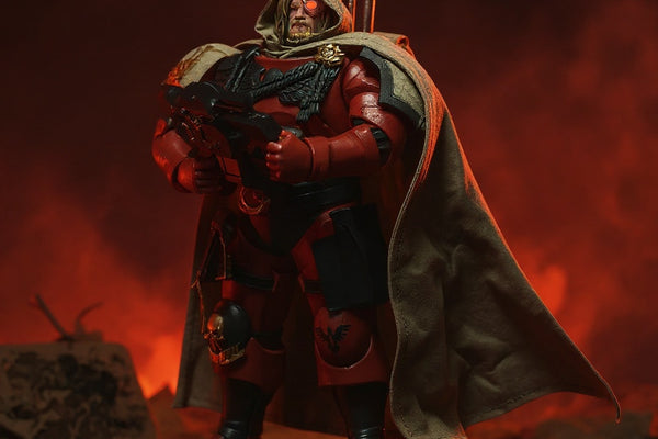 Dark red-black fabric action figure cape with visible hand-stitched seams, posed on figure in hellscape diorama with dramatic red lighting.