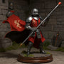 Flowing red and black wire-posable cloth cape on a 7-inch armored knight action figure, dynamic windswept pose, set against a medieval castle stone diorama with sword, shield, moss, fog, and LED-lit wooden base.