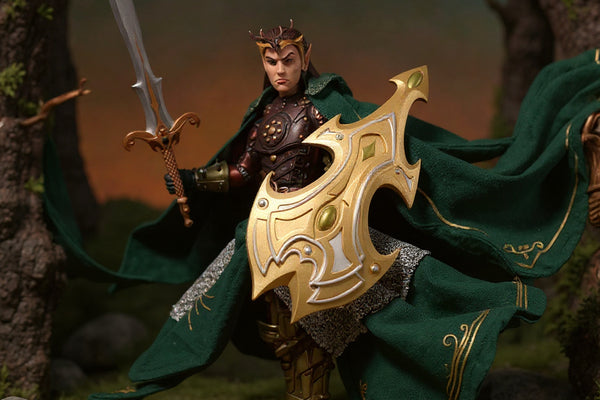 A dark green and brown fabric action figure cape with wire-shaped folds, draped over a small fantasy figure's shoulders, set in a miniature forest diorama with moss and rocks, under dramatic warm lighting.