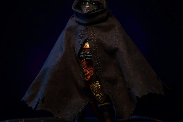 Tattered dark gray-brown fabric cloak draped over action figure torso on a moonlit gothic rooftop diorama, with rat figurines and dramatic side lighting.
