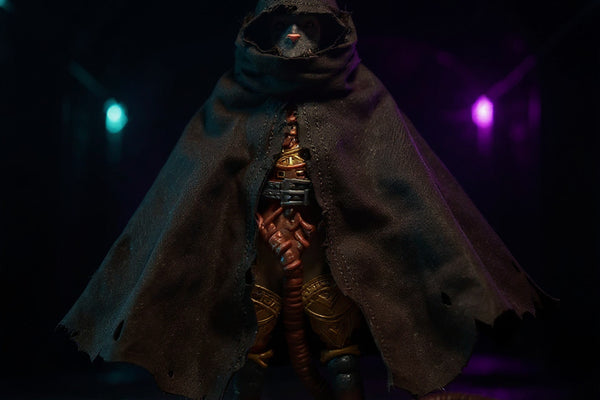 Tattered dark gray-brown fabric cloak with frayed edges draped over an action figure torso in a neon-lit gothic sewer tunnel, high contrast bold colors.