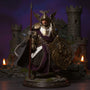 Dark fabric knight's cloak with wire-shaped flowing hem draped over 1/12 scale armored knight action figure on mossy rock base, before miniature stone castle backdrop, dramatic purple-blue gradient lighting.