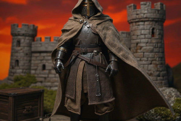 Soft fabric cape in weathered brown-tan hues billowing on a 1/12 scale crusader archer figure against a dramatic medieval stone castle backdrop with bright crimson-amber gradient sky, wooden crate, moss rock, and bow prop.