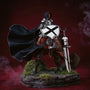 Deep blue flowing fabric cape with wire-shaped folds draped over armored knight action figure on stone diorama with moss, sword and shield, dramatic lighting, bold gradient background.