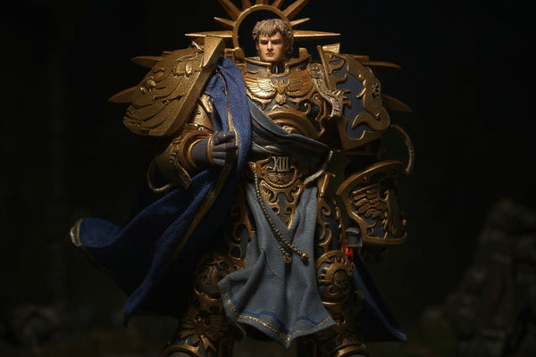 Deep blue fabric cloak with gold trim on a 1/18 scale armor torso, set in Warhammer ruins with dramatic spotlight and deep shadows.