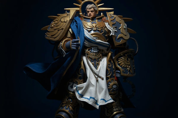 Deep blue fabric cloak with gold trim on an action figure torso, displayed on a ruins base with dramatic spotlight against a dark gradient background.