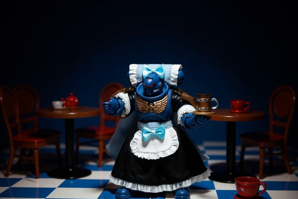 Miniature maid costume on an articulated figure in a café diorama with tea set, bold blue and white background, dramatic lighting.