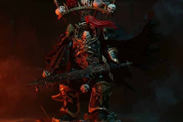 Tattered black fabric cape draped over miniature warhammer armor figure in dark stone ruins with dramatic red lighting.