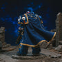 Deep blue fabric cape with gold trim and purity seal draped over a 1/18 action figure shoulder in a miniature battlefield diorama with dramatic spotlighting.