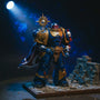 Deep blue action figure cape with gold trim and purity seal draped over shoulder on battlefield diorama, dynamic pose.