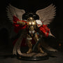 Golden and crimson fabric cape with wire frame displayed on a ruined cathedral diorama base with dramatic lighting.