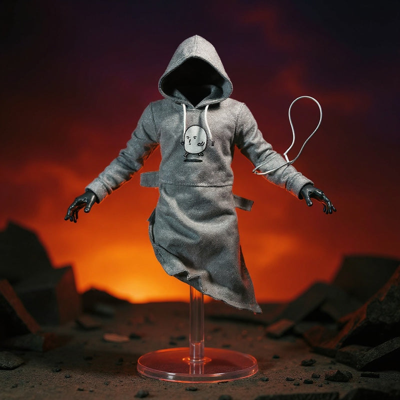 Grey hooded cloth top for 1/12 figures posed on a stand in a ruined city diorama with dramatic spotlight and gradient sky.