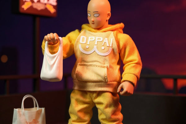Hero shot of a 1/12 scale soft fabric yellow jumpsuit with white accents on a bald superhero action figure, posed on an urban rooftop diorama with grocery bags and noodle cup, under dramatic neon lighting.