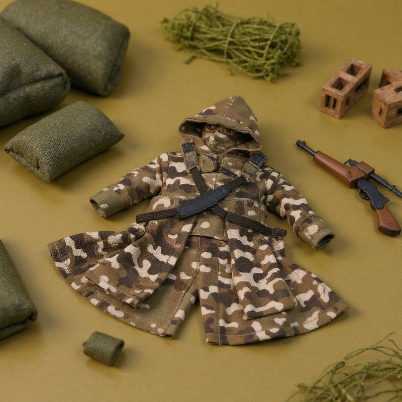 Miniature camo tactical coat and pants set laid flat on a green-to-tan gradient background surrounded by military diorama props.
