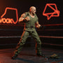 1/12 scale khaki military fabric outfit on a headless articulated figure frame, staged in a fighting game arena diorama with tactical props and arcade cabinet backdrop.