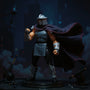 Black fabric cape with red trim on Shredder-style action figure, posed on dark rooftop with neon skyline and ninja weapons.