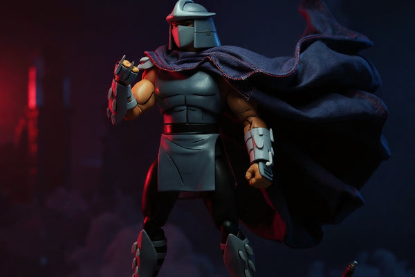 Black fabric cape with red trim on a dark armored Shredder figure, rooftop diorama with neon skyline, sai and katana props, fog, dramatic side lighting.