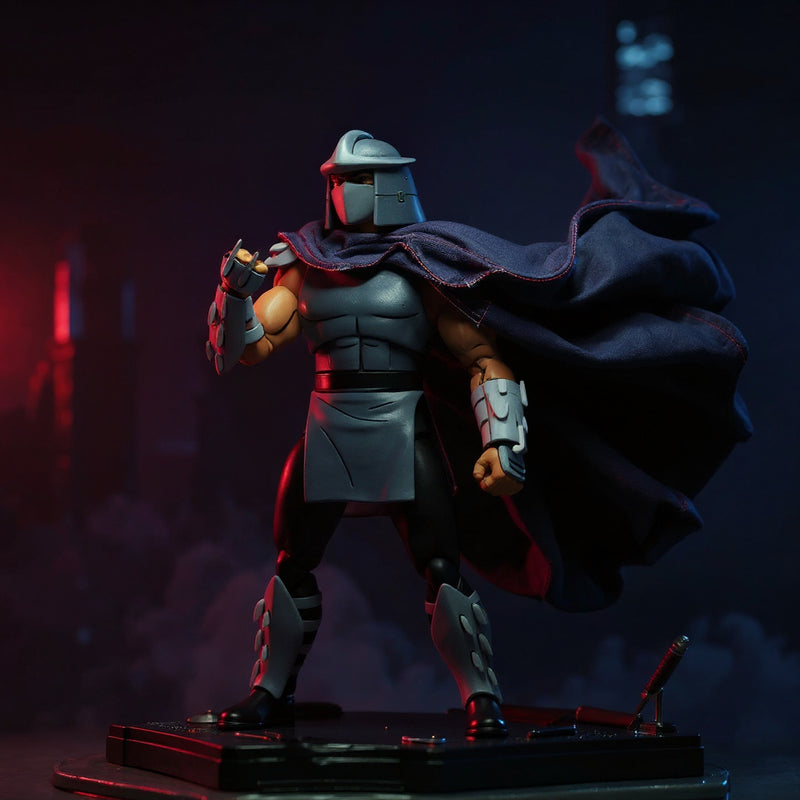 Black fabric cape with red trim on a dark armored Shredder figure, rooftop diorama with neon skyline, sai and katana props, fog, dramatic side lighting.