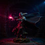 Dark tattered cloak with internal wire frame displayed in dramatic fantasy ruins under vibrant colored lighting.