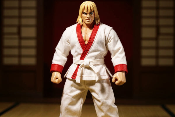 White karate gi with red trim on headless action figure in a dojo with dramatic lighting