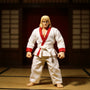White karate gi with red trim on headless action figure in a dojo with dramatic lighting