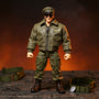 Miniature military uniform on battle-damaged diorama with dog tags and tactical belt