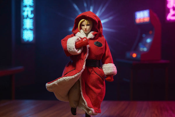 Small red fabric military-style jacket on mannequin form in miniature dojo diorama with neon arcade signs