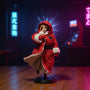 Small red fabric military-style jacket on mannequin form in miniature dojo diorama with neon arcade signs