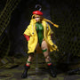 Bright yellow 1/12 scale military cropped jacket displayed on clear hanger in military diorama with camo netting, miniature combat boots and tactical gloves.
