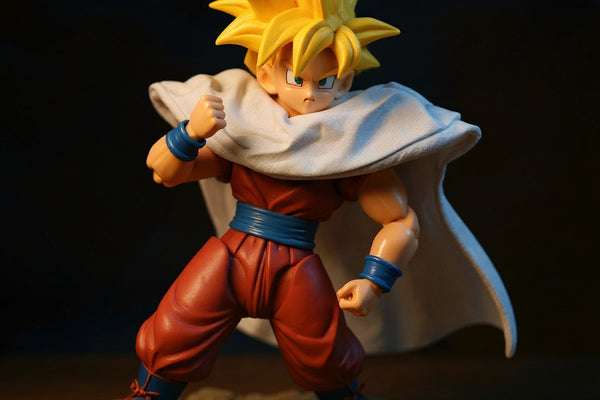 Small fabric cape with wire hem draped on Gohan action figure on rocky diorama with Dragon Balls, dramatic lighting