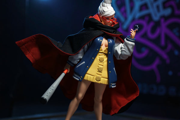 Dark cape on action figure posed on urban rooftop diorama with neon graffiti and streetlight, fan creating dynamic flow.