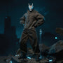 Dark tactical protective suit on a headless 1/12 scale action figure body, displayed on miniature urban rubble diorama with LED glow and rooftop backdrop.