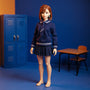 Navy blue and white 1/12 scale school uniform outfit on a faceless mannequin in a bold miniature classroom diorama with lockers, desk, and backpack, against a blue-orange gradient background.