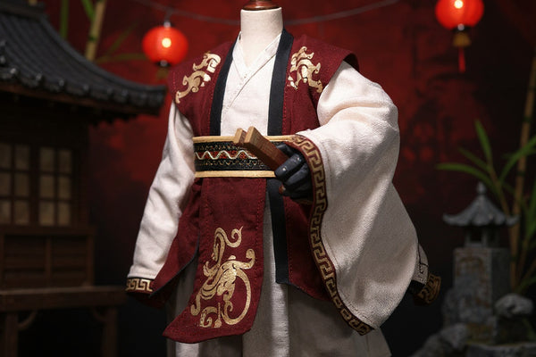 Chinese-style cloth cape with layered fabric and gold accents draped on a small figure frame, set against a bold red-to-black gradient background with miniature pavilion, bamboo, and red lanterns, dramatic lighting.