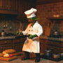 Miniature white chef jacket, apron, and small hat on a mohawk goblin figure in a bold miniature kitchen scene.