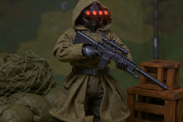 Tactical 1/12 scale fabric jacket displayed in miniature military diorama with sandbags and crates.