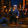 Miniature blue denim jacket displayed on a wooden stand against a bold urban cityscape backdrop with denim swatches and Capsule Corp props, dramatic lighting.